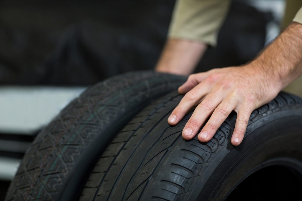 Mechanics hands touching spare tires